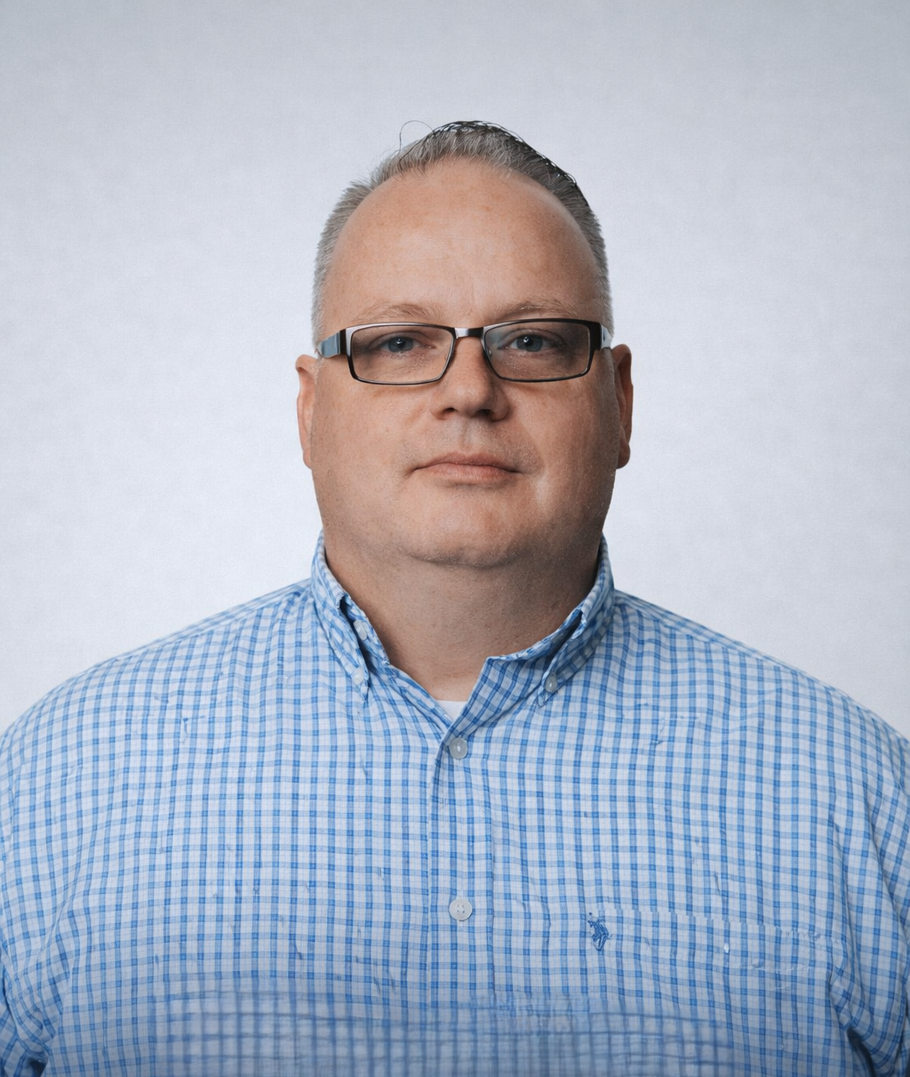 A picture of a man in glasses and blue shirt